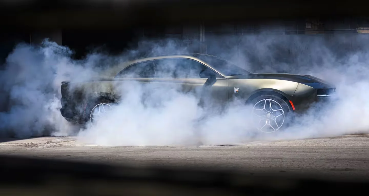 2026 Dodge Charger performing a burnout with thick tire smoke, emphasizing performance.